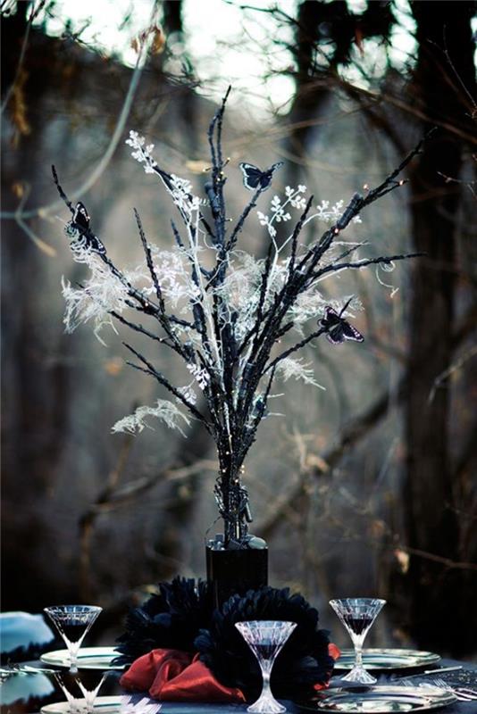 Halloween -bröllop i skogen, bukett svartmålade torkade blommor och kvistar med pappersfjärilar