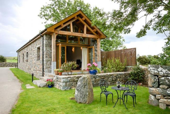 تأثيث-a-barn-facade-in-stone-wooden-roof-arch-garden-well-soine-wormed-iron-الكراسي