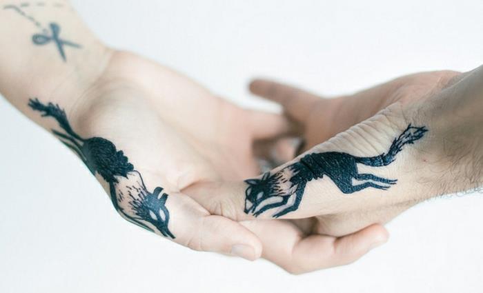idé för en tatuering på båda händernas fingrar, vargmönster, manlig tatuering