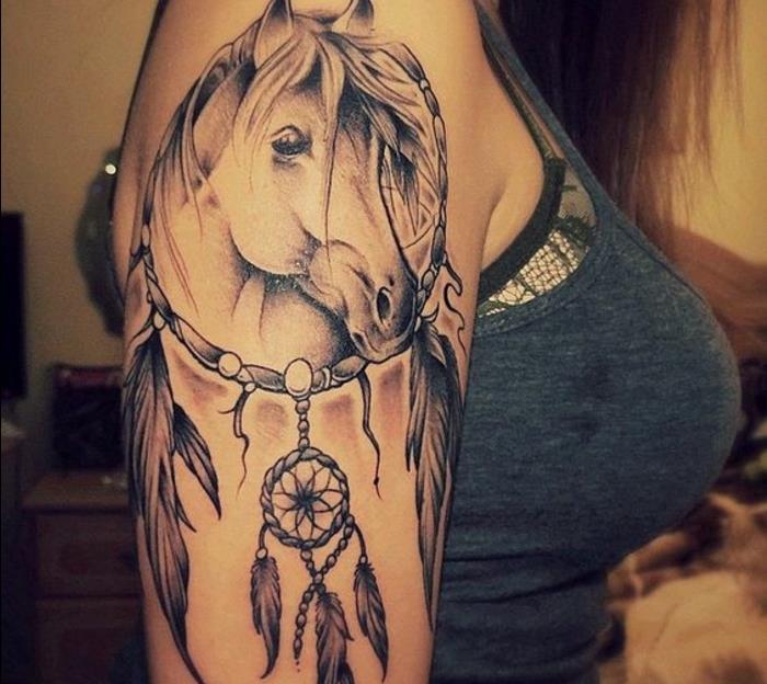 dreamcatcher -tatuering, stor båge med hästdesign inuti och en liten dreamcatcher, grafiska fjädrar
