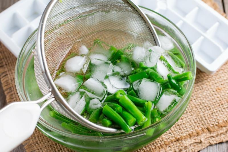 blanšírujte zelené fazuľky zelené fazuľky v miske kociek ľadu