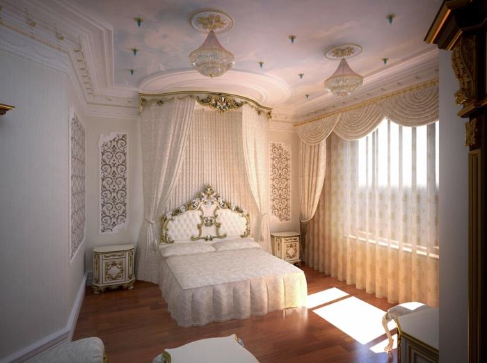 elegant lantlig inredning, vitt sängbord med gyllene konturer, himmelssäng, kristallkrona