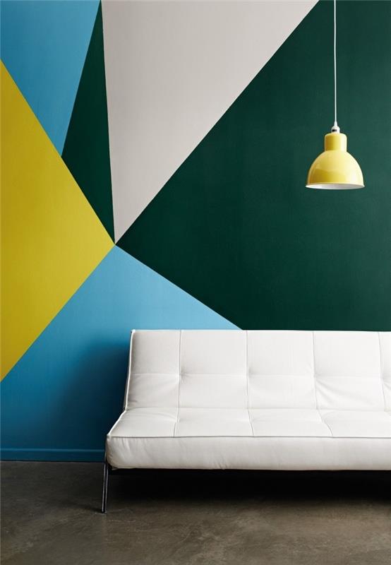 biela pohovka žltá závesná lampa geometrický obraz stena obývačka trojuholníkové tvary farby tmavozelená farba trend