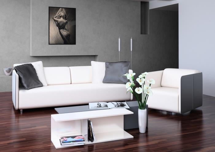 rozloženie obývačky s betónovými textúrami, moderný nábytok do obývačky s rozkladacím kreslom a dvojitým konferenčným stolíkom v bielej a sivej farbe