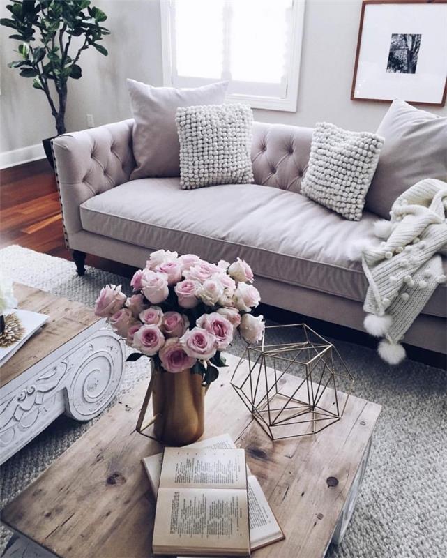 kokande kudde vävd med ullbollar som passar med en varm pläd för en soffa i hygge -stil, grått och rosa vardagsrum i skandinavisk stil