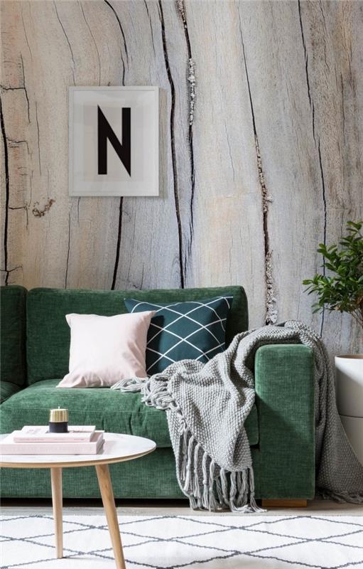mysig grön soffa med vanliga eller grafiska kuddar i grönt och rosa, placerade mot en vägg täckt med trompe-l'oeil tapet