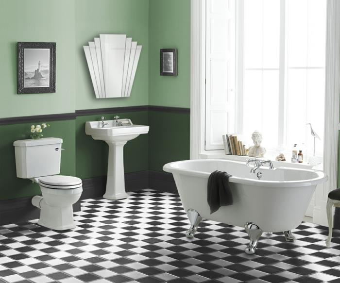 jednoduchá kúpeľňa s kockovanými dlaždicami, biela vaňa, ozdobné zrkadlo, veľké okno, biela soška, ​​knihy na parapete