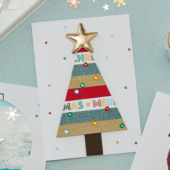 بطاقة عيد الميلاد لرياض الأطفال في شرائط لامعة ملونة بأحجار الراين الملونة والنجمة الذهبية على ورق أبيض زينة عيد الميلاد لرياض الأطفال