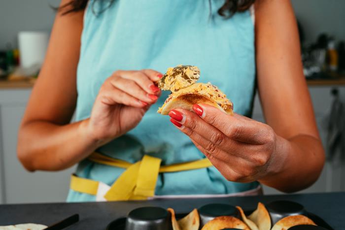 Ripieno tortillas, donna che cucina, mini tacos con ripieno, donna azzurro grembiule