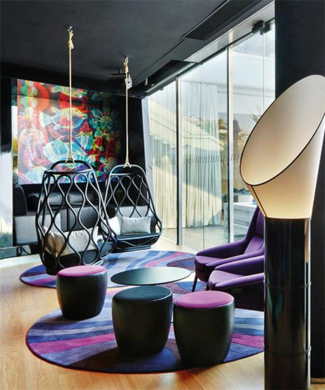 hängande äggstol, två hängande stolar i ett ultra modernt vardagsrum med en abstrakt målning