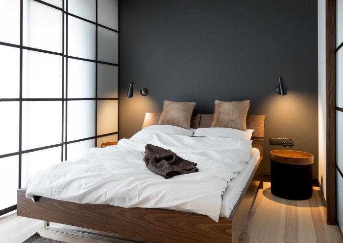 hur man separerar sovrummet från vardagsrummet med ett glas och matt svart separation, varm atmosfär med grå vägg och ljus träparkett