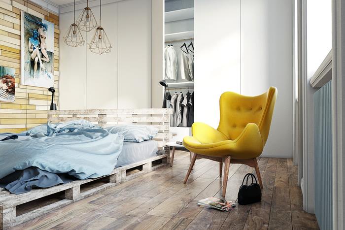 škandinávska spálňa v bielom a drevenom prevedení s paletovou posteľou a stenou z dosiek z recyklovaného dreva