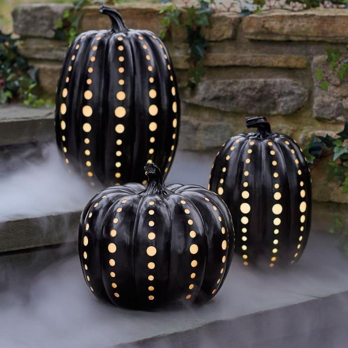 halloween dekoration att göra, lysande pumpa målad i svart för exteriör halloween stil