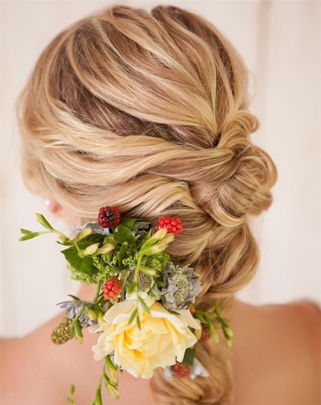 bröllopsfrisyr med en flätad knutstil genomskinad med en bukett blommor i håret