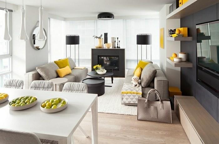 Arredare salotto piccolo, divani di tessuto grigio, decorazione con cuscini gialli