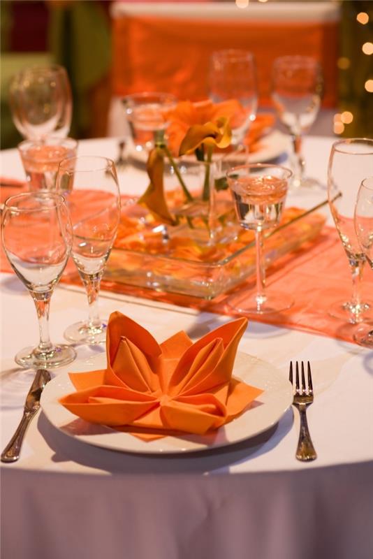 urobte ľahký lotosový kvet s oranžovým papierovým obrúskom, štýlovým usporiadaním stola v bielej a oranžovej farbe