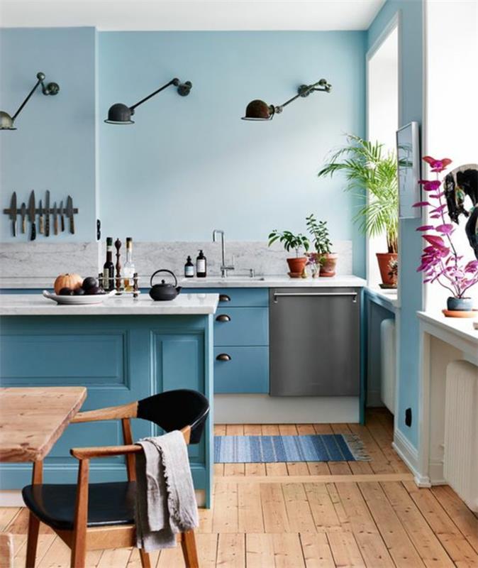 kačica modrá dekorácia kačica modrá nábytok tri skladacie čierne kovové svetlá na stenu, parkety zo svetlého dreva, stôl a stolička v zodpovedajúcich farbách