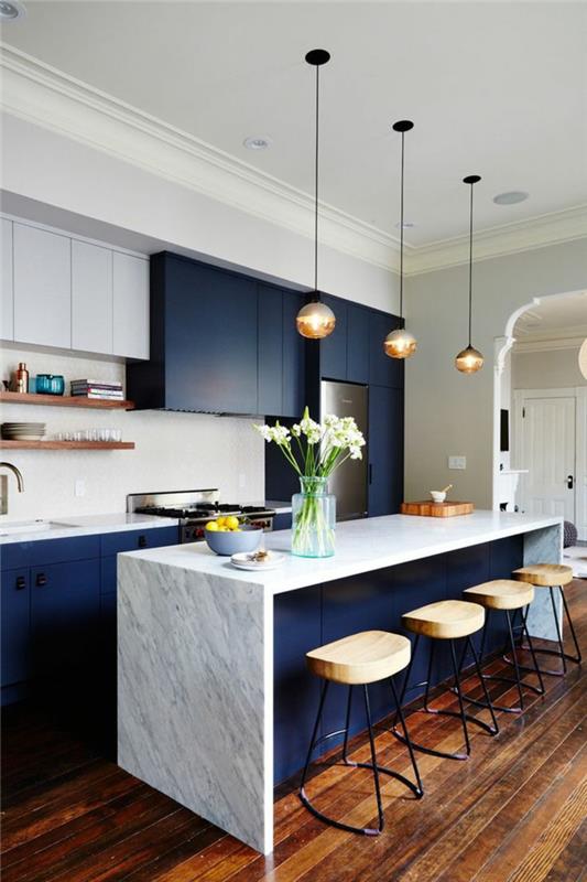 مطبخ باللونين الأبيض والأزرق ، مقاعد خشبية صغيرة ، أرضية خشبية ، جدار مع تخزين أنيق