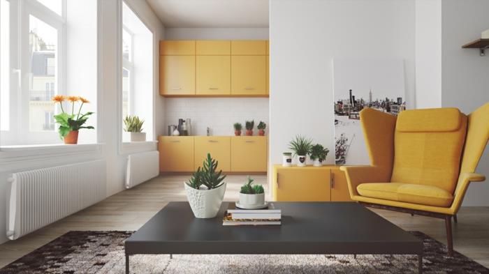 kuchyňa otvorená do obývačky, biely škandinávsky dekor, s horčicovo žltými akcentmi, predná časť kuchyne, žltá úložná jednotka a pohovka, čierny konferenčný stolík, čierny a sivý koberec