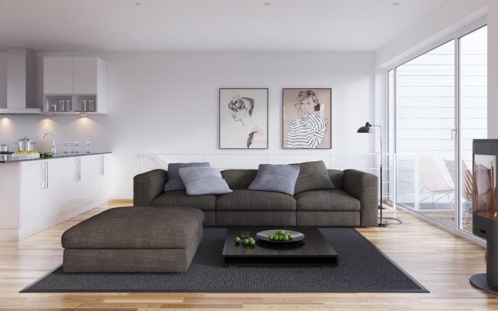 Škandinávska výzdoba obývačky a jedálne, svetlé parkety, sivý koberec a pohovka, konferenčný stolík, biela predná časť kuchyne, ženské portréty