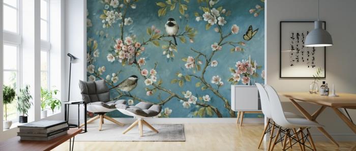 Maľované papierové dekorácie na stenu kvitnúca vetva s malým vtáčikom dobre zariadenou obývacou izbou