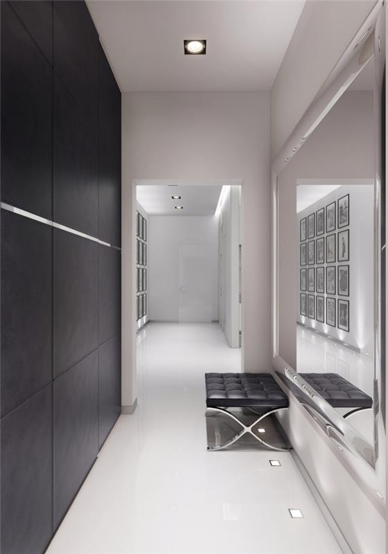 dekoration lång och smal vit hall med en svart accentvägg och en stor spegel som visuellt expanderar utrymmet