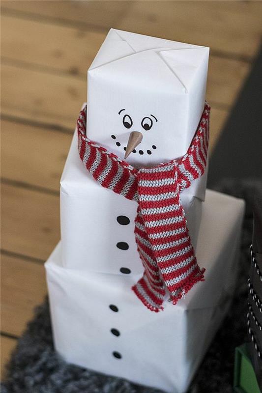 DIY vianočný snehuliak vyrobený z troch bielych balíčkov a bavlnenej šatky, s červeno -bielymi horizontálnymi pruhmi, originálny nápad na balenie rodinných darčekov