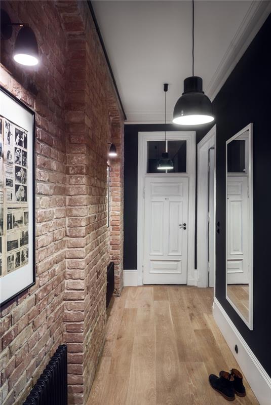 industriell loftstil med tegelvägg som matchar perfekt med svart på motsatt vägg och industriell belysning