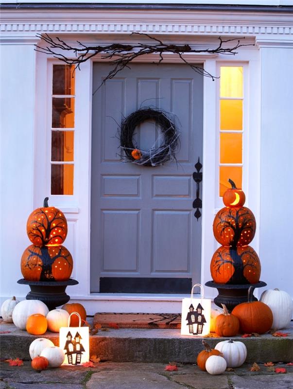 halloween manuell aktivitet, vitmålade pumpor med svarta trädesigner och inre belysning