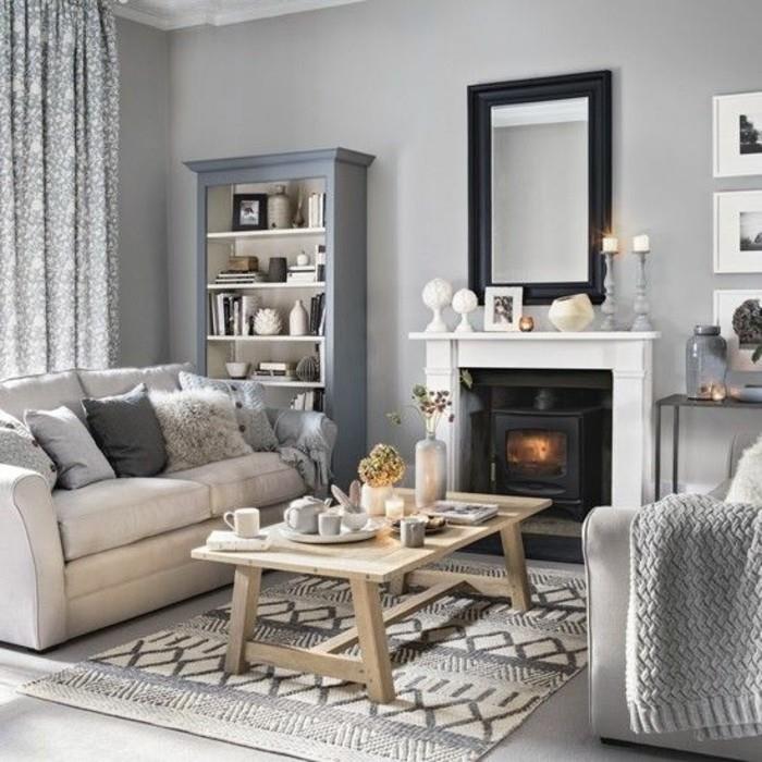 moderná-sivá-ladená-obývačka-dekor-a-malé-biele akcenty-romantický-krb-drevený-stôl-pre-útulnú-škandinávsku-obývačku