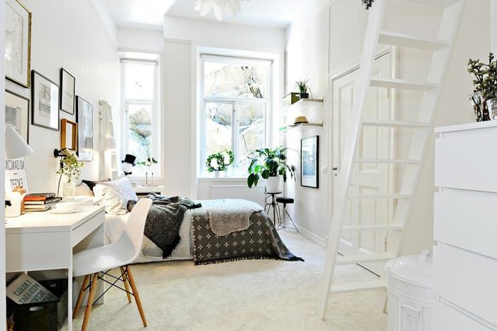 Škandinávsky biely stôl a stolička, biely koberec, sivá a biela posteľná bielizeň, dekorácia steny rámu obrazu, zelené rastliny