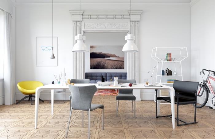 Škandinávsky nábytok do obývačky, biely stôl, sivé stoličky, biele závesné svetlá, žlté kreslo a biela stena, originálna polica, drevená podlaha