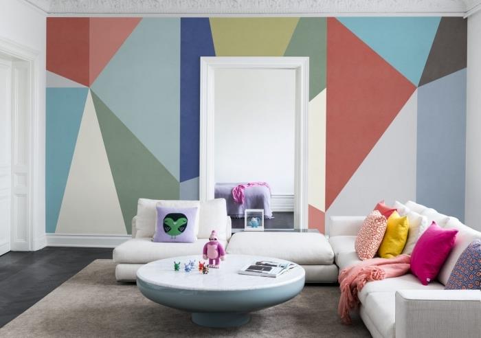 trend interiérového dizajnu geometrický obraz obývačka stena akcent biela rohová sedačka dekoračné vankúše okrúhly konferenčný stolík