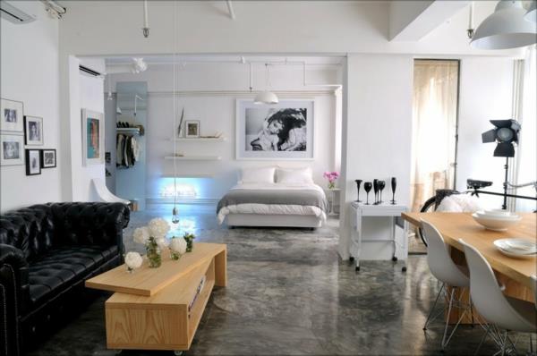 loft-anda-en-lägenhet-med-trämöbler-och-svart-läder-soffa
