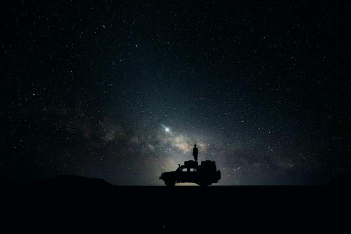 خلفية مجانية للكمبيوتر ، صورة منظر ليلي ومركبة تحت سماء مظلمة متناثرة