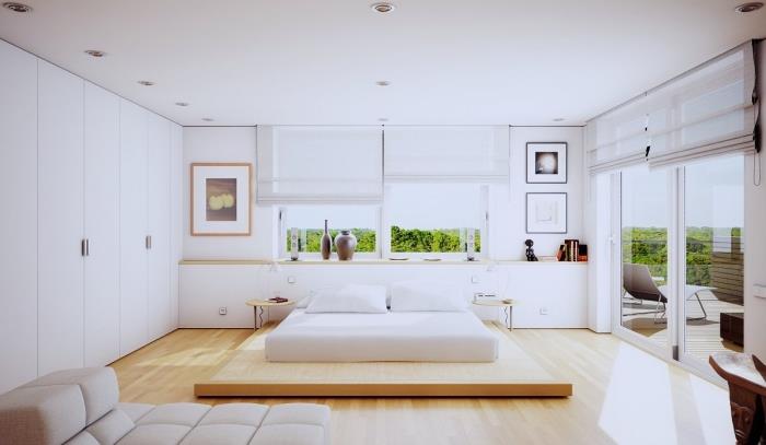 färg för modernt designat sovrum med vit garderob och ljus träparkett, väggdekoration med målningar