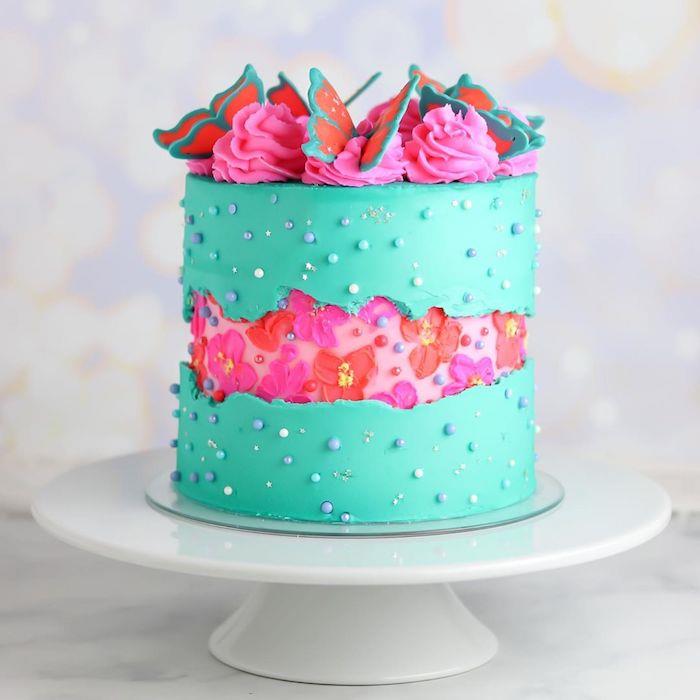 exempel felkaka med central remsa dekorerad med rosa grädde och rosa och röda blommor, tårta dekorerad med sockerfjärilar ovanpå