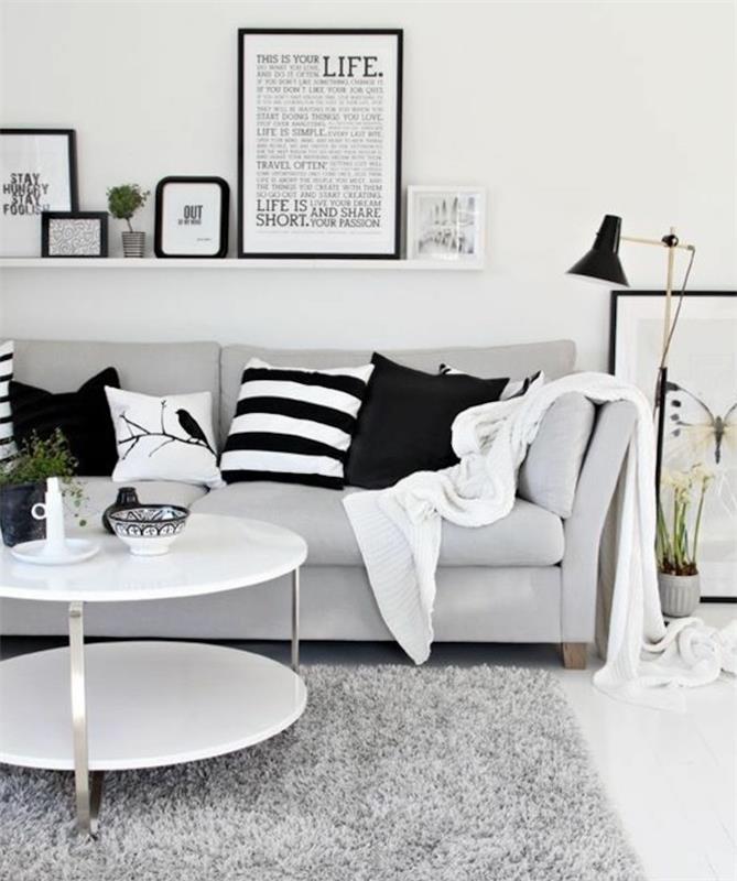inramad konst ,, på en hängande hylla, vitt soffbord, ljusgrå soffa, vilka färger matchar med grått