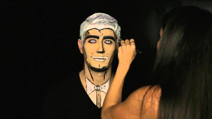 popkonstsmink för män, vitt hår, konturer av svarta ögon, neonfärgade linser, kostym och fjäril målad på halsen