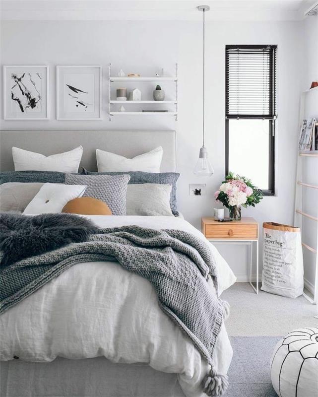 grått sovrum, modern inredning i skandinavisk stil, hängande lampa, tavelramar, trä och vitt sängbord
