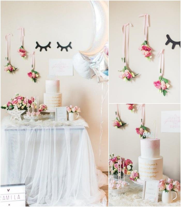 mjuk och luftig dekoration av en enhörningsfödelsedagsbuffé med en tyllbordskjol, hängande buketter av blommor och ballonger av silverfolie