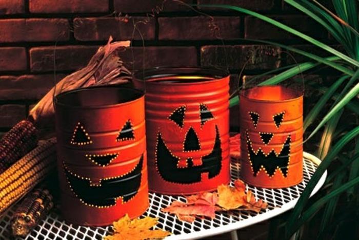 DIY halloween -idé, orange ljusstakar tillverkade i burkar med lyktor, med hål, plåtburk