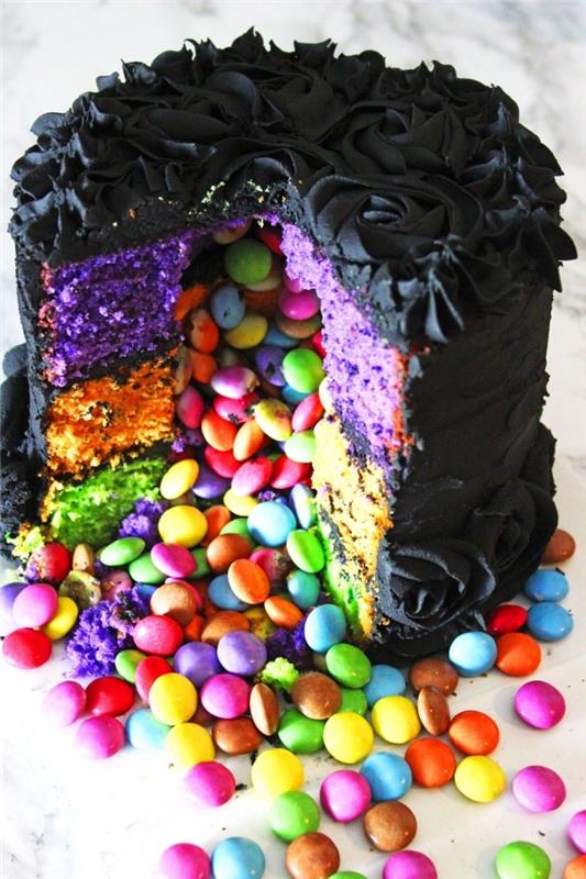 Halloween pinata tårta med svart rosglasyr, som döljer färgad sockerkaka och mångfärgade godis inuti