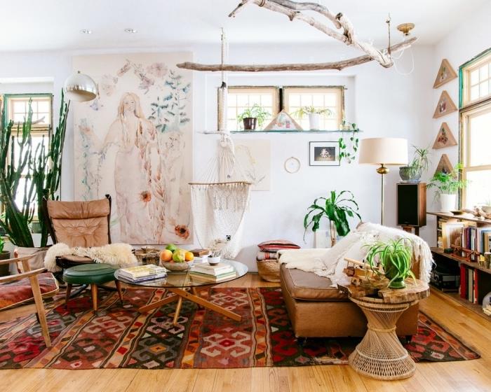 atmosféra boho chic štýlu v obývačke s bielymi stenami s drevenými parketami, farebným vzorom etnických kobercov