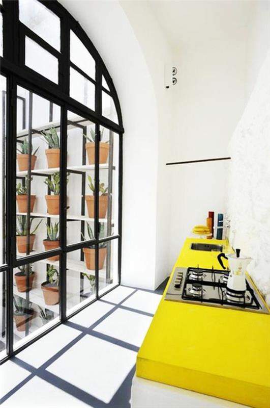 vackert-litet-kök-med-gula-möbler-vita-väggar-och-vitt-tak