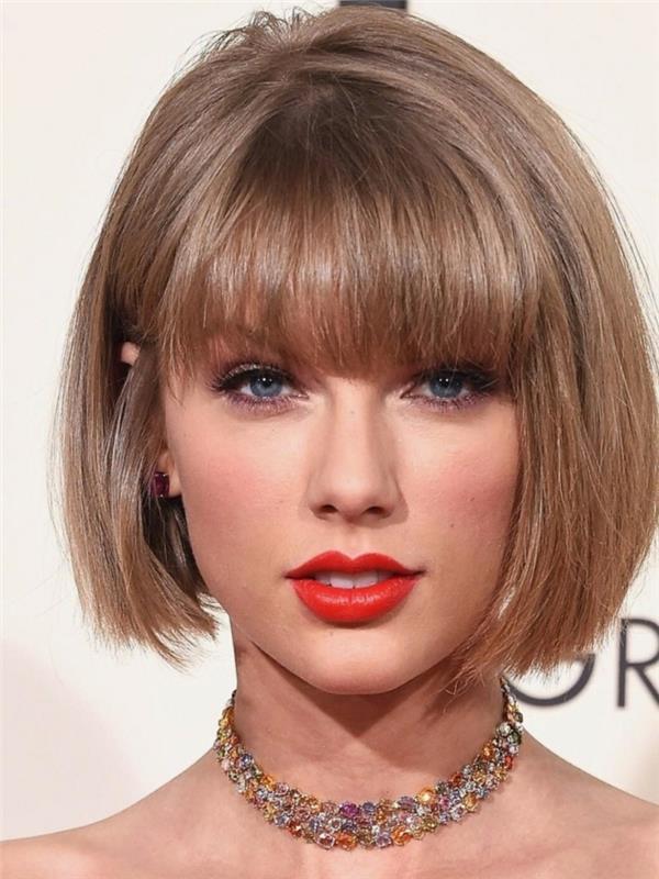 Taylor Swift asymmetrisk störande bob, röda läppar, svart eyeliner, rak lugg, askblont hår