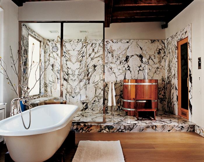 sklenená sprchová zástena, drevená podlaha, drevená komoda, mramorové steny sprchového kúta