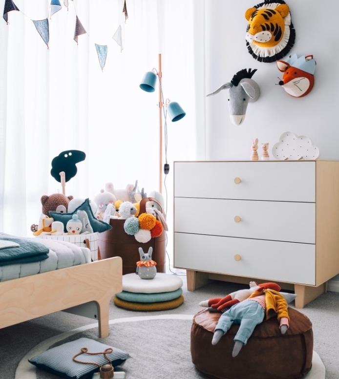 škandinávsky nábytok do detskej izby, drevená posteľ a komoda, sivý koberec, hnedý puf, hračky uložené v taškách, dekorácia steny zvierat
