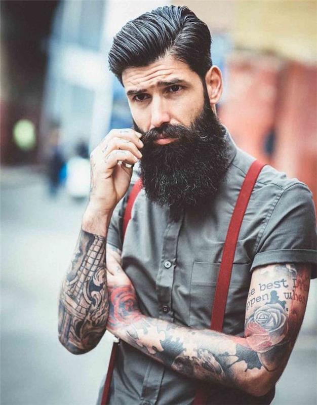 hipster modell man med stort skägg pompadour cut tatueringar hängslen