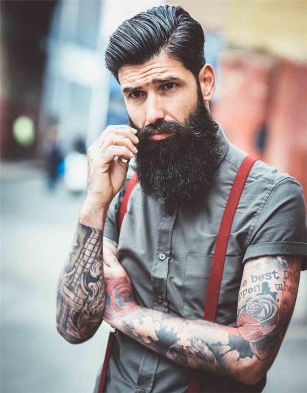 hipster modell man med stort skägg pompadour cut tatueringar hängslen
